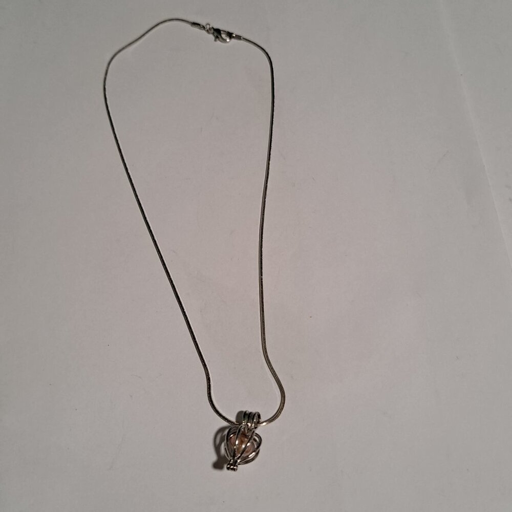 hinged pendant that opens to hold anything you want on a silver color chain - Picture 3 of 4